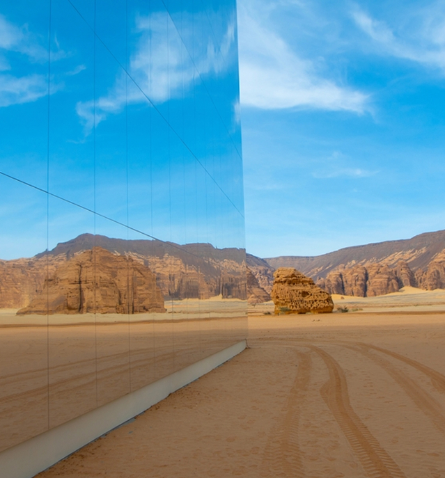 Modern glass architecture reflecting sky and landscape
